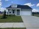Charming, single story home features a 1-car garage, light green siding and covered front porch at 242 Letha Dr, Longs, SC 29568