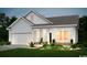Charming single-Gathering home with a well-manicured lawn and attached two-car garage at 257 Eagle Claw Dr., Calabash, NC 28467