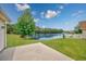 Backyard featuring a lake view with a white picket fence and grass at 286 Bonnie Bridge Circle, Myrtle Beach, SC 29579