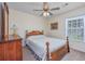 Cozy bedroom with a floral comforter, a ceiling fan, and a view of the backyard at 286 Bonnie Bridge Circle, Myrtle Beach, SC 29579