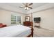 Bedroom with ceiling fan, window, and dark wood furnishings at 286 Bonnie Bridge Circle, Myrtle Beach, SC 29579