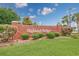 A community sign with brick trim, lush bushes and plants, and a manicured lawn at 286 Bonnie Bridge Circle, Myrtle Beach, SC 29579