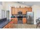 Functional kitchen featuring updated appliances, hardwood cabinets, and a view of the adjoining dining area at 286 Bonnie Bridge Circle, Myrtle Beach, SC 29579