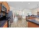 Modern kitchen equipped with stainless steel appliances and hardwood cabinets with seamless access to living room at 286 Bonnie Bridge Circle, Myrtle Beach, SC 29579