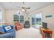 Bright living room with ceiling fan, large window, and patio doors with waterfront view at 286 Bonnie Bridge Circle, Myrtle Beach, SC 29579