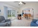Comfortable living room featuring ceiling fan and access to outdoor patio at 286 Bonnie Bridge Circle, Myrtle Beach, SC 29579