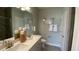 Bright bathroom features double sink vanity with framed mirror, tiled floors, and plenty of storage at 293 Eagle Claw Dr., Calabash, NC 28467