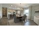 Elegant dining area adjacent to the kitchen, featuring modern lighting and comfortable seating for Gathering meals at 293 Eagle Claw Dr., Calabash, NC 28467