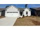 Charming single-story home with a two-car garage and well-maintained lawn on a sunny day at 293 Eagle Claw Dr., Calabash, NC 28467