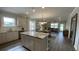 Bright, open kitchen with granite countertops, stainless steel appliances, and seamless flow to the living space at 293 Eagle Claw Dr., Calabash, NC 28467