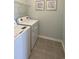 Functional laundry room with modern washer and dryer units and clean, organized space at 293 Eagle Claw Dr., Calabash, NC 28467