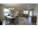 Spacious living room with large windows, comfortable seating, and an open layout perfect for entertaining at 293 Eagle Claw Dr., Calabash, NC 28467