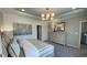 Comfortable main bedroom features horizontal shiplap accent wall, calming decor, and soft natural light at 293 Eagle Claw Dr., Calabash, NC 28467