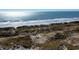 Scenic view of sandy beach with dunes, offering ocean views and a serene coastal lifestyle at 3019 Dover Branch Dr., Little River, SC 29566