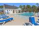 Inviting community pool with ample seating surrounded by trees, perfect for relaxation and recreation at 3019 Dover Branch Dr., Little River, SC 29566