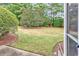 A sprawling lawn and mature landscaping define this private backyard space at 307 River Rock Ln. # 906, Murrells Inlet, SC 29576