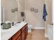 Elegant bathroom featuring double sinks, vanity, and a separate bathtub at 307 River Rock Ln. # 906, Murrells Inlet, SC 29576