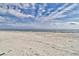Expansive view of the beach showcasing soft sand and beautiful blue skies at 307 River Rock Ln. # 906, Murrells Inlet, SC 29576