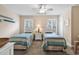 Charming bedroom with two twin beds, a ceiling fan, and plenty of natural light at 307 River Rock Ln. # 906, Murrells Inlet, SC 29576
