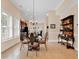 Formal dining area featuring a glass table, decorative bar, and abundant natural light at 307 River Rock Ln. # 906, Murrells Inlet, SC 29576