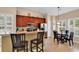 Modern kitchen with stainless steel appliances, a breakfast bar, and an adjacent dining area at 307 River Rock Ln. # 906, Murrells Inlet, SC 29576