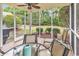 A screened porch featuring a tile floor, ceiling fan, and outdoor furniture at 307 River Rock Ln. # 906, Murrells Inlet, SC 29576