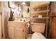 Practical bathroom featuring functional fixtures, patterned wallpaper, and storage shelves at 312 73Rd Ave. N # 15, Myrtle Beach, SC 29572