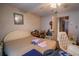 Bedroom with a comfortable bed, fan, and a vintage chair at 312 73Rd Ave. N # 15, Myrtle Beach, SC 29572