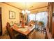 Well-lit dining room with a wooden table set, enhanced by a decorative window at 312 73Rd Ave. N # 15, Myrtle Beach, SC 29572