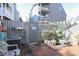 Outdoor patio with tiled floor, surrounded by a wooden fence and flourishing greenery for privacy at 312 73Rd Ave. N # 15, Myrtle Beach, SC 29572