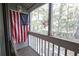 Screened porch adorned with American flags, offering a patriotic and relaxing outdoor space at 312 73Rd Ave. N # 15, Myrtle Beach, SC 29572