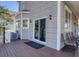 View of the spacious back deck of the home featuring outdoor seating and access to the house via sliding glass door at 406 26Th Ave N, North Myrtle Beach, SC 29582