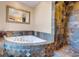 Luxurious bathroom with a jetted tub, stone accents, and a separate walk-in shower at 406 26Th Ave N, North Myrtle Beach, SC 29582