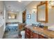 Elegant bathroom featuring a soaking tub, tiled accents, and a copper sink vanity at 406 26Th Ave N, North Myrtle Beach, SC 29582