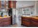 Charming kitchen with wood cabinets, stainless steel refrigerator, and an adjacent dining area with ample natural light at 406 26Th Ave N, North Myrtle Beach, SC 29582