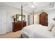 Spacious main bedroom featuring a four-poster bed, tray ceiling with fan, and a large dresser with a TV at 417 Pennington Loop, Myrtle Beach, SC 29588