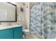 Functional bathroom featuring a toilet, sink, mirror, and a patterned shower curtain at 4350 Intercoastal Dr. # 2207, Little River, SC 29566