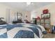 Bedroom featuring a patterned quilt, TV, and a window at 4350 Intercoastal Dr. # 2207, Little River, SC 29566