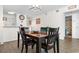 A well-lit dining area with a classic dining set and an open view to other rooms at 4350 Intercoastal Dr. # 2207, Little River, SC 29566