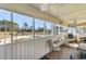 A screened porch with an open view and comfortable seating at 4350 Intercoastal Dr. # 2207, Little River, SC 29566