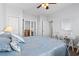 Bright bedroom with a ceiling fan, white furniture and blue bedding at 4517 Planters Row Way, Myrtle Beach, SC 29579