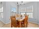 Inviting dining area with wood table, seating for six, neutral colors, and natural light from dual windows at 4517 Planters Row Way, Myrtle Beach, SC 29579