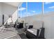 Relax on the spacious porch with comfortable seating, stylish rug, and serene views of the outdoors at 4517 Planters Row Way, Myrtle Beach, SC 29579