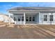 Large back porch with white columns offers an outdoor living space overlooking the yard at 5501 Bristle Cone Ct., Myrtle Beach, SC 29577