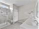 Bathroom with a glass-enclosed shower, double vanity, and neutral tile at 5501 Bristle Cone Ct., Myrtle Beach, SC 29577