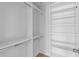 Walk-in closet with white shelving, hanging racks, and wood-look flooring at 5501 Bristle Cone Ct., Myrtle Beach, SC 29577