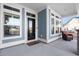 Charming front porch featuring a seating area, complemented by windows and a welcoming entrance at 5501 Bristle Cone Ct., Myrtle Beach, SC 29577