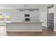 Kitchen with white cabinets, granite countertops, stainless steel appliances, and large island at 5501 Bristle Cone Ct., Myrtle Beach, SC 29577