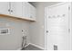 Laundry room featuring overhead cabinets, hook rack, and in-wall utility connections at 5501 Bristle Cone Ct., Myrtle Beach, SC 29577