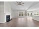 Spacious living room with a fireplace, wood-look flooring, and an open floor plan at 5501 Bristle Cone Ct., Myrtle Beach, SC 29577